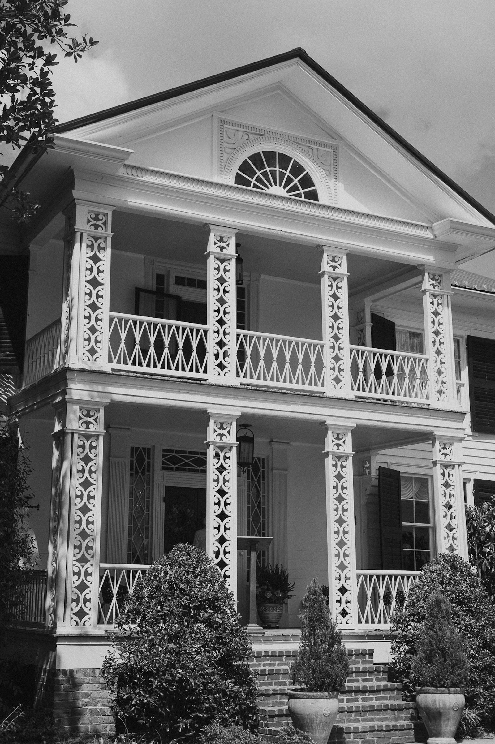 Southern-style home exterior with columns, shutters and balcony