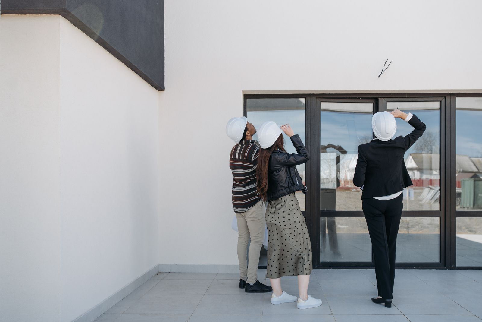 Property professionals reviewing an exterior building during an inspection